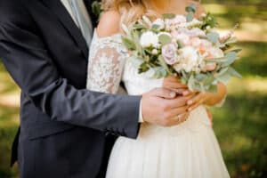 Woman holding flowers wearing a wedding gown